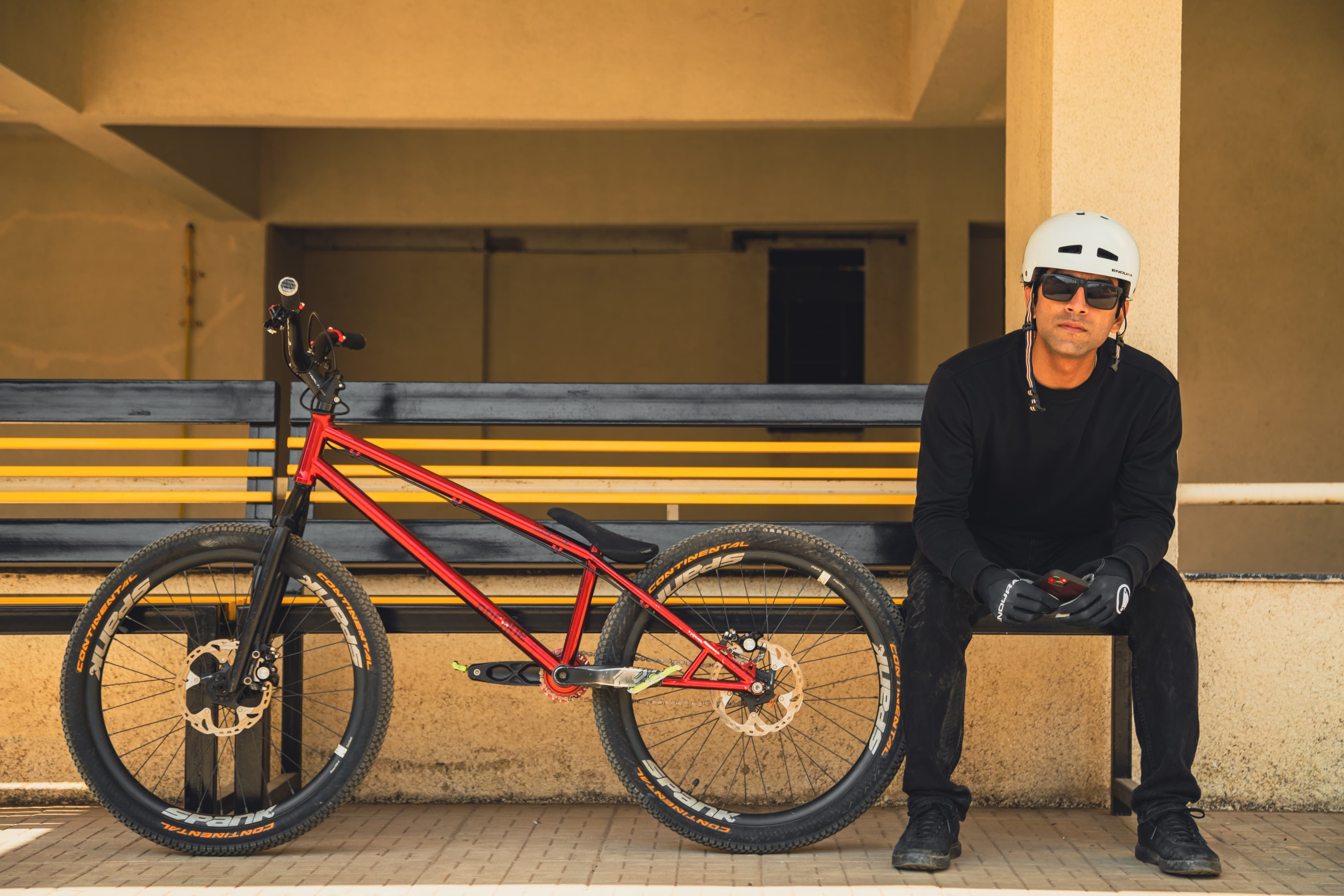 Ronn seated beside his trials bike